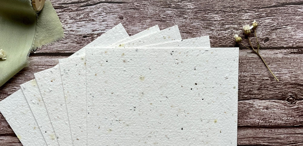 A La KArt Creations exclusive seed paper, laid out on a wooden backdrop with wildflowers.