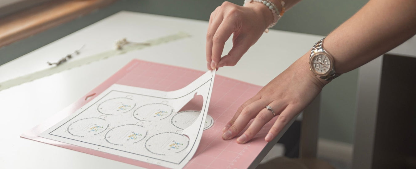 A photograph of Kitti, A La Kart Creations founder, creating plantable candle dust covers in her studio.
