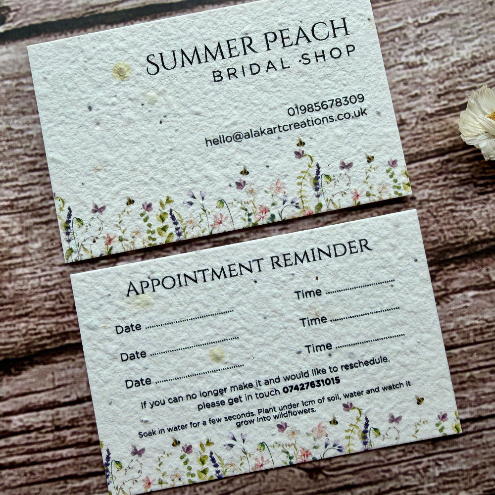 Seed paper appointment reminder card from Summer Peach Bridal Shop on a wooden surface.