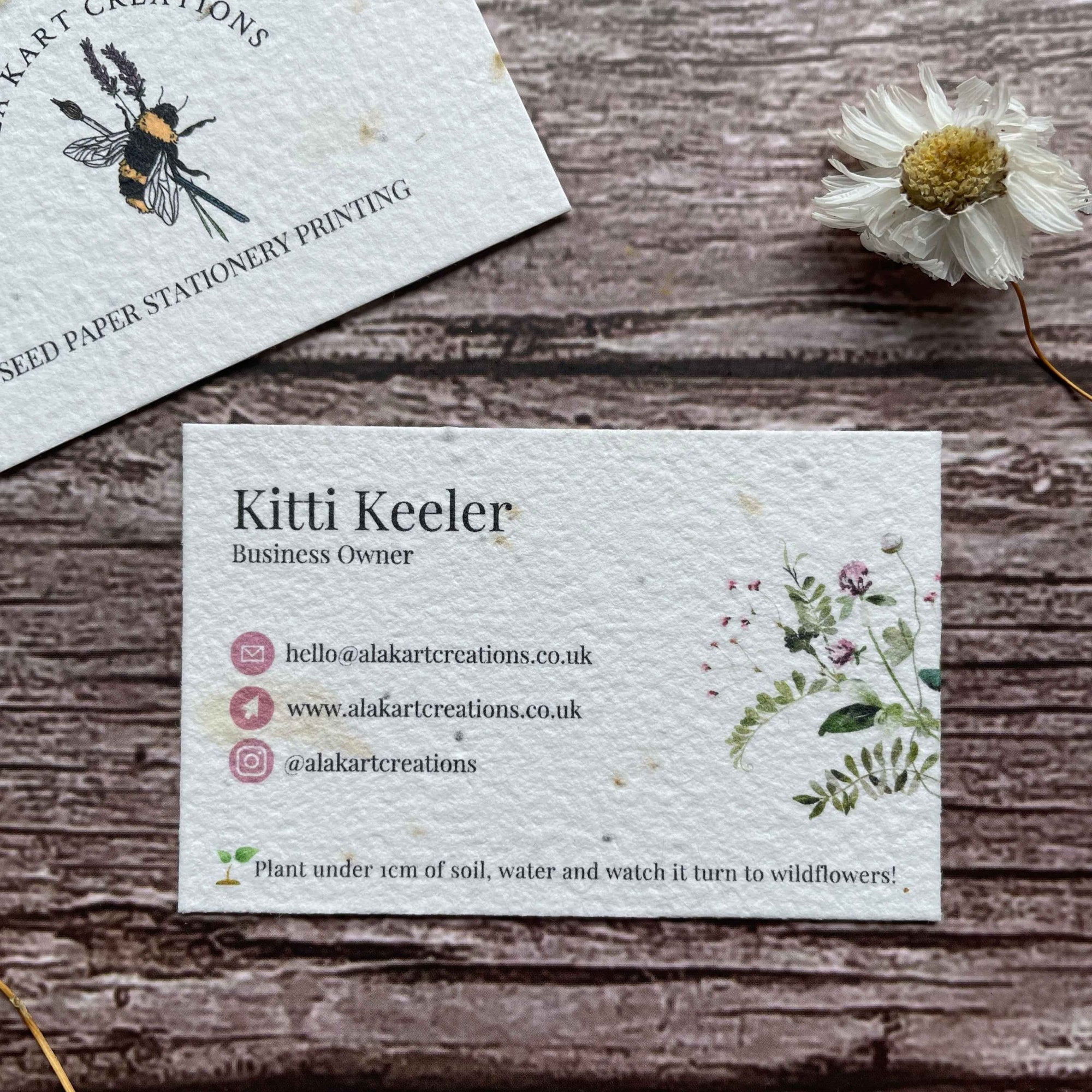plantable wildflower seed paper business card with pink logos, showcasing eco-friendly design and sustainable branding, from a la kart creations