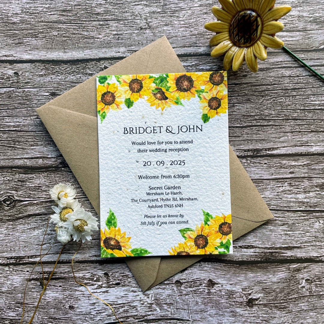 plantable evening guest wedding invitations in sunflowers theme, front view with eco-friendly brown kraft envelope, floral design on wooden background