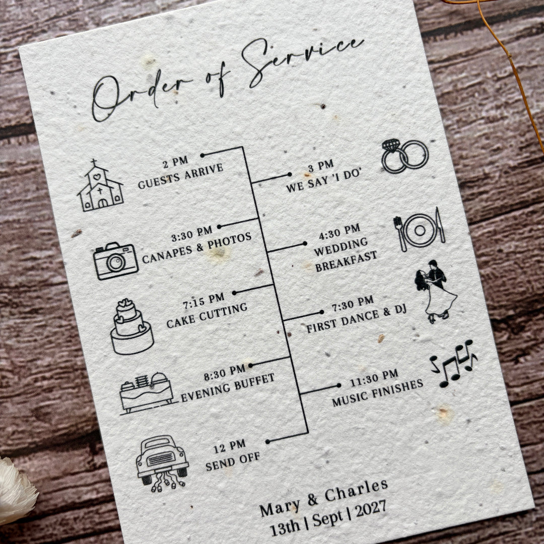 Wedding seed paper order of service card with icons on a wooden surface