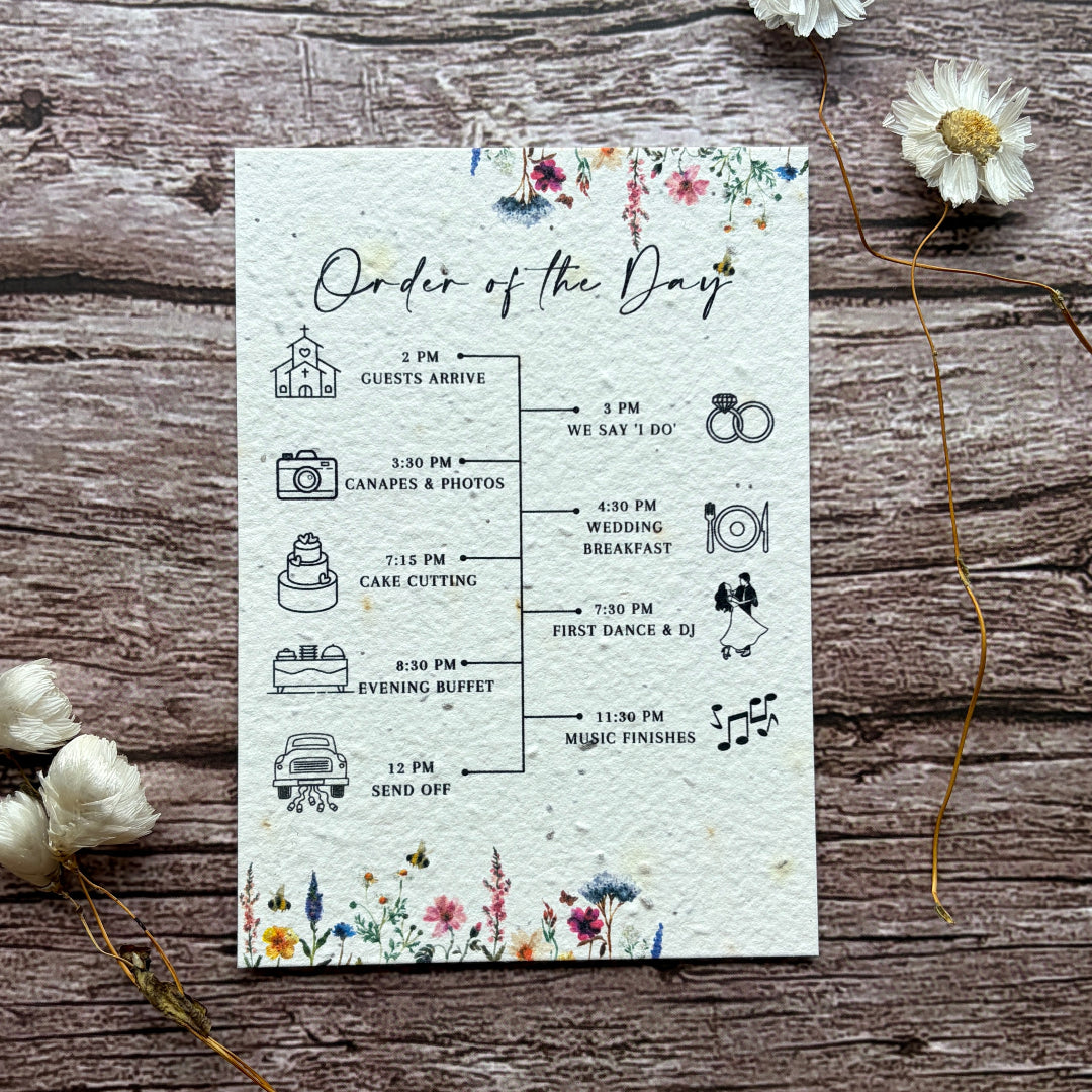 plantable seed paper order of the day cards with wildflower meadow design on a wooden surface