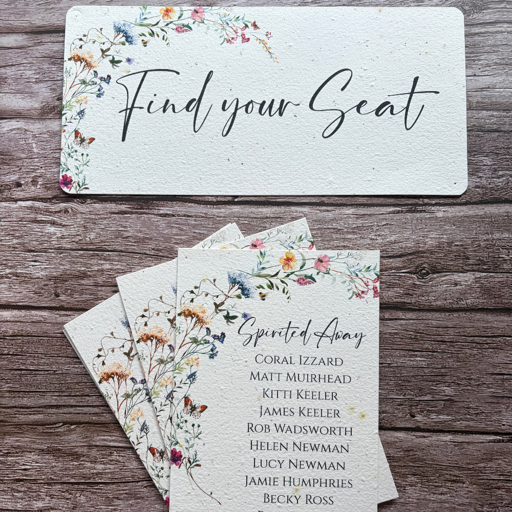 A wedding plantable seating card set displayed on a rustic wooden background, featuring a large &