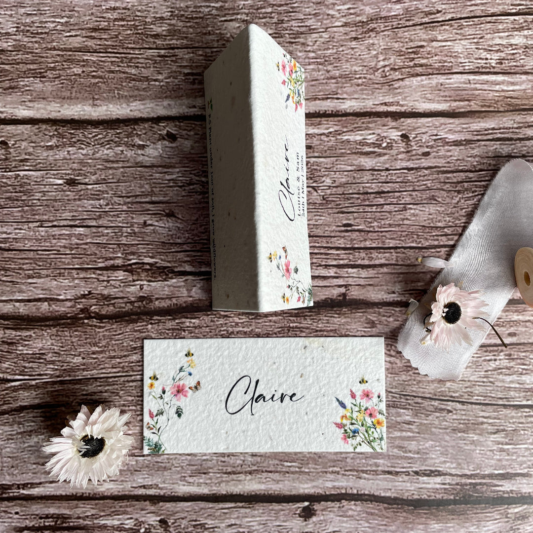 Personalised wedding name card wooden surface with floral designs.