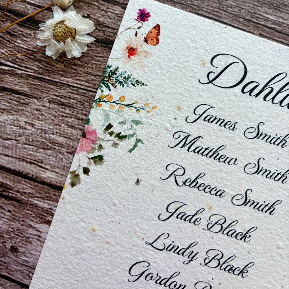 plantable seed paper wedding table seating plan with wildflower design on a wooden background