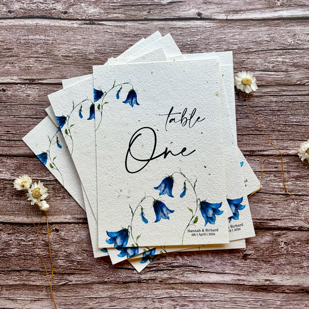 plantable wedding table names or number bluebells design on wooden background