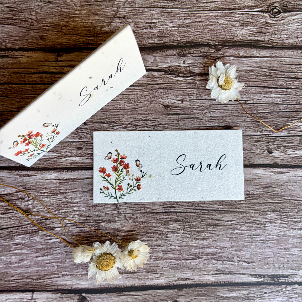 Two plantable name cards with floral designs and &
