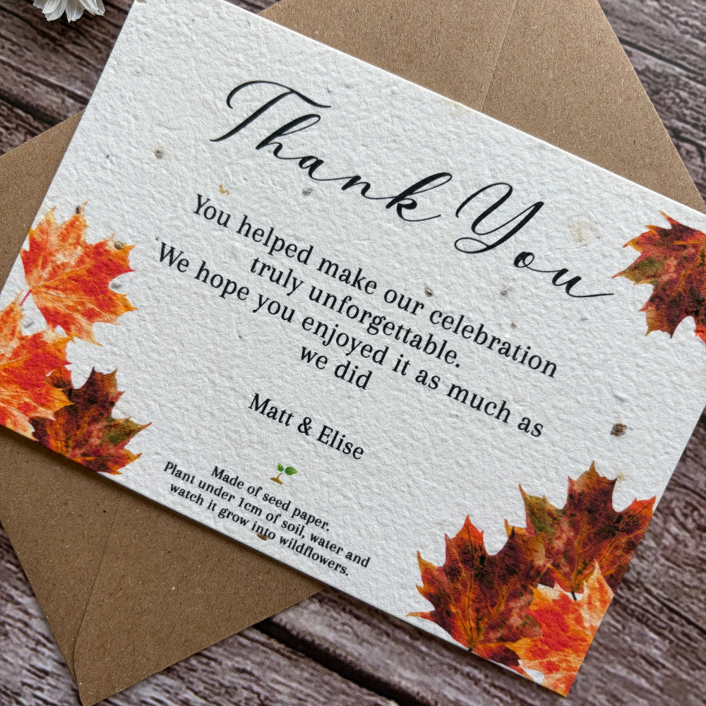 Plantable wedding Thank you card with autumn leaves design on a wooden surface