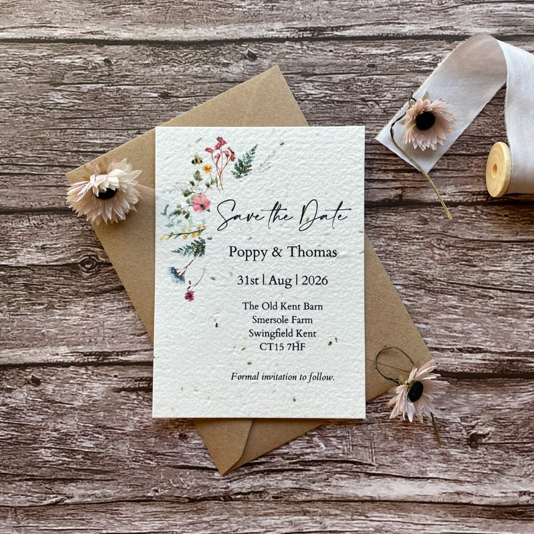 personalised plantable save the date card with wildflower meadow design and kraft envelope, flat lay style, alakartcreations