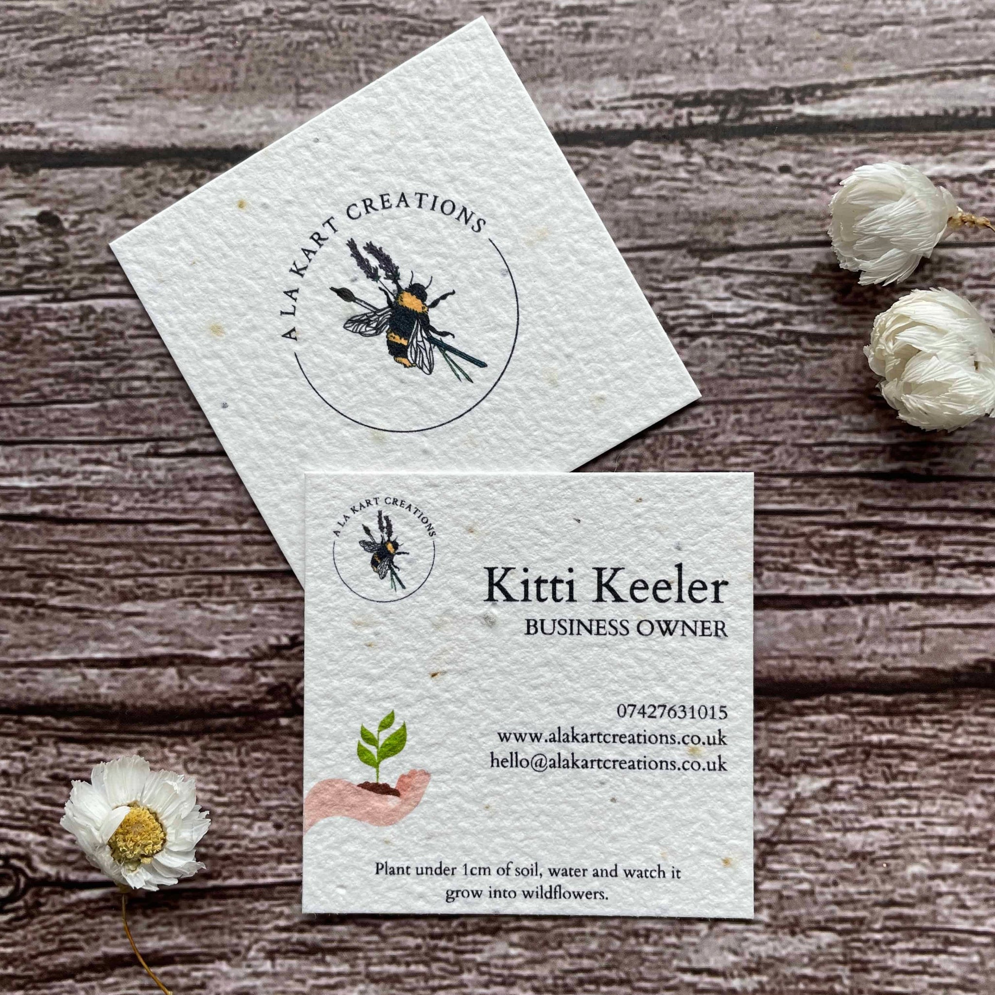 square plantable seed paper business cards with sustainable future design featuring hand holding growing seedling, alakartcreations