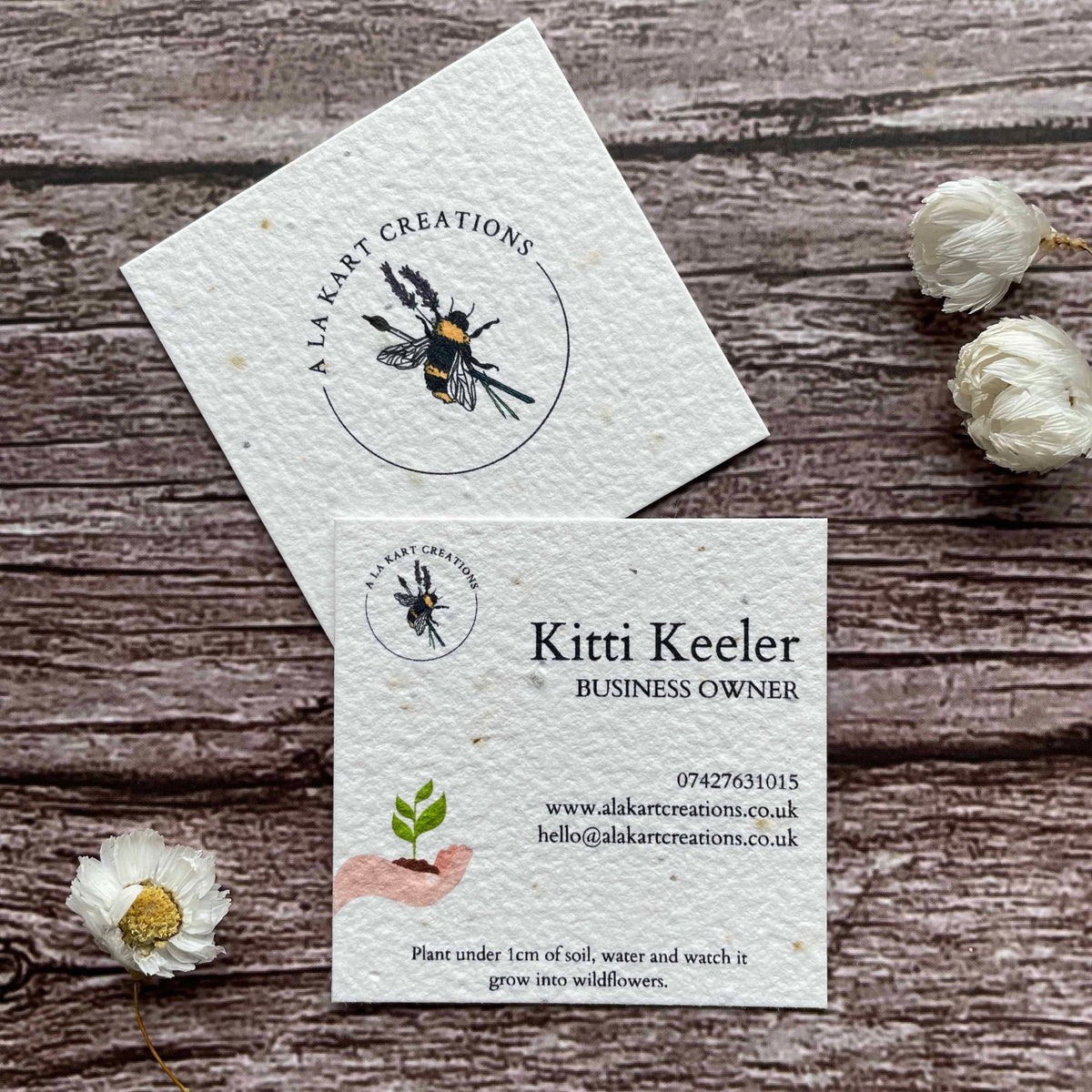 square plantable seed paper business cards with sustainable future design featuring hand holding growing seedling, alakartcreations
