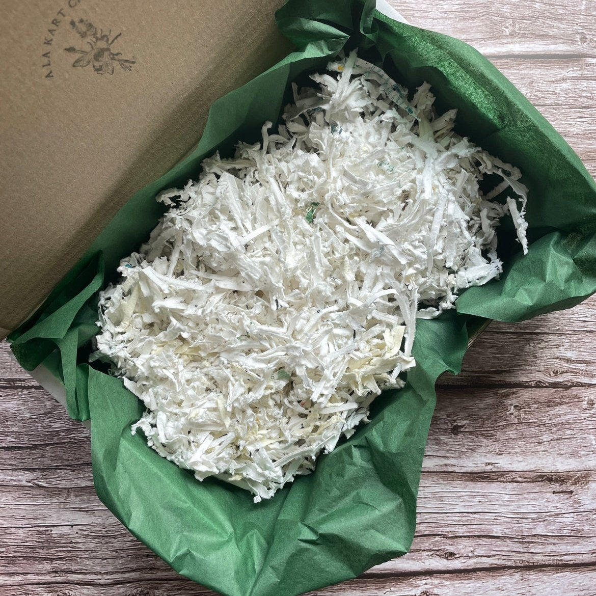 Right angled view of 1kg Plantable Shredded Box Filler showcasing the shredded plantable material.
