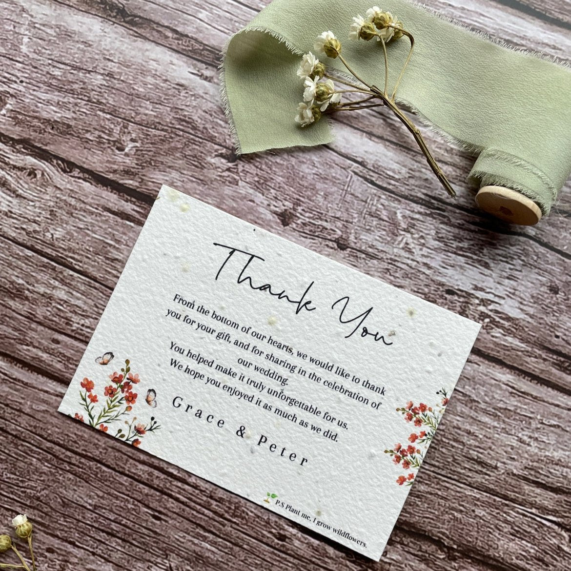 plantable seed paper wedding thank you cards in burnt orange theme, angled view with floral design on wooden background, eco-friendly, alakartcreations