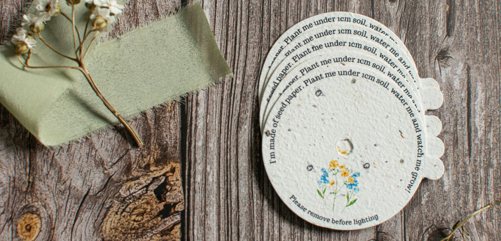 A range of A La KArt Creations plantable candle dust covers, laid out on a wooden backdrop with dried flowers.