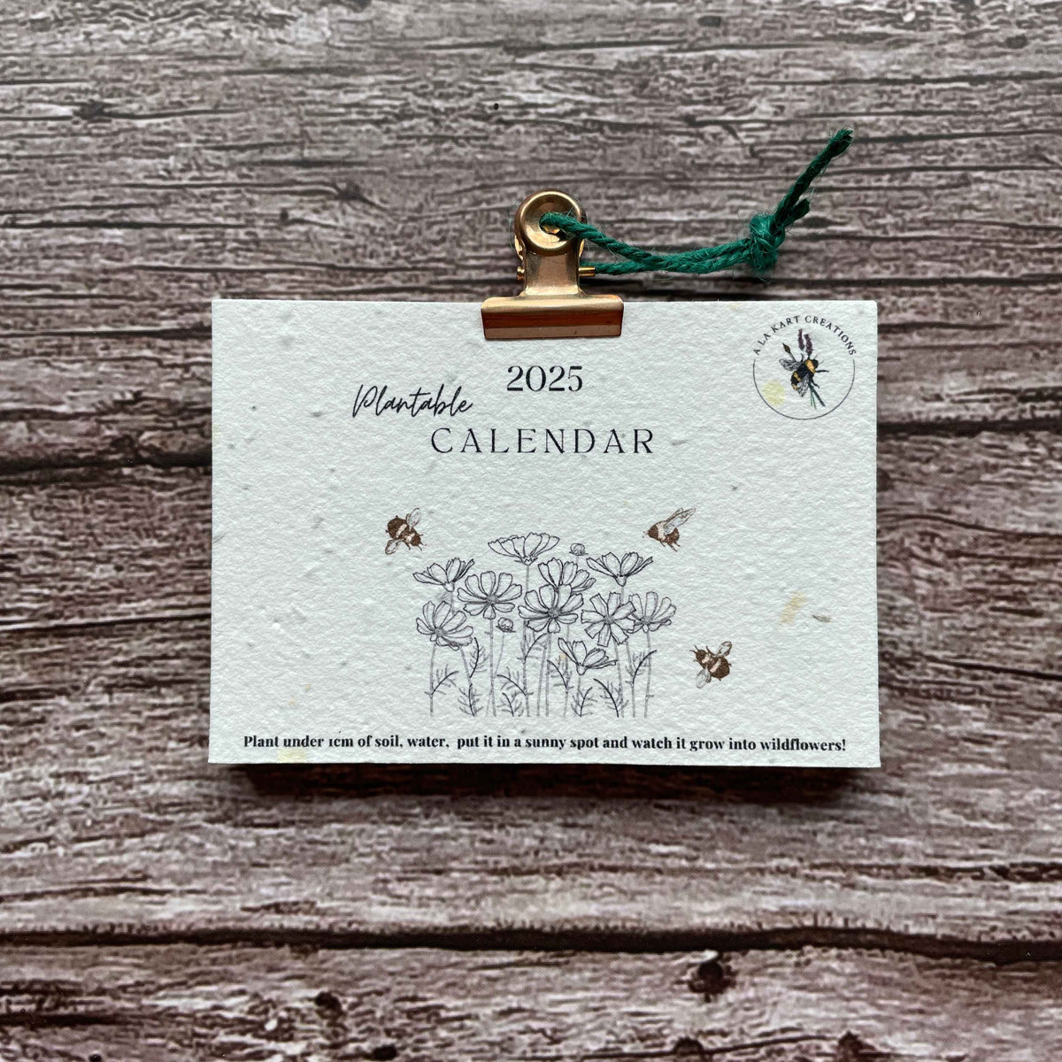 2025 plantable seed paper calendar titled "Honeybee Harmony," featuring eco-friendly design and seed paper materials, promoting sustainability and support for pollinators, alakartcreations