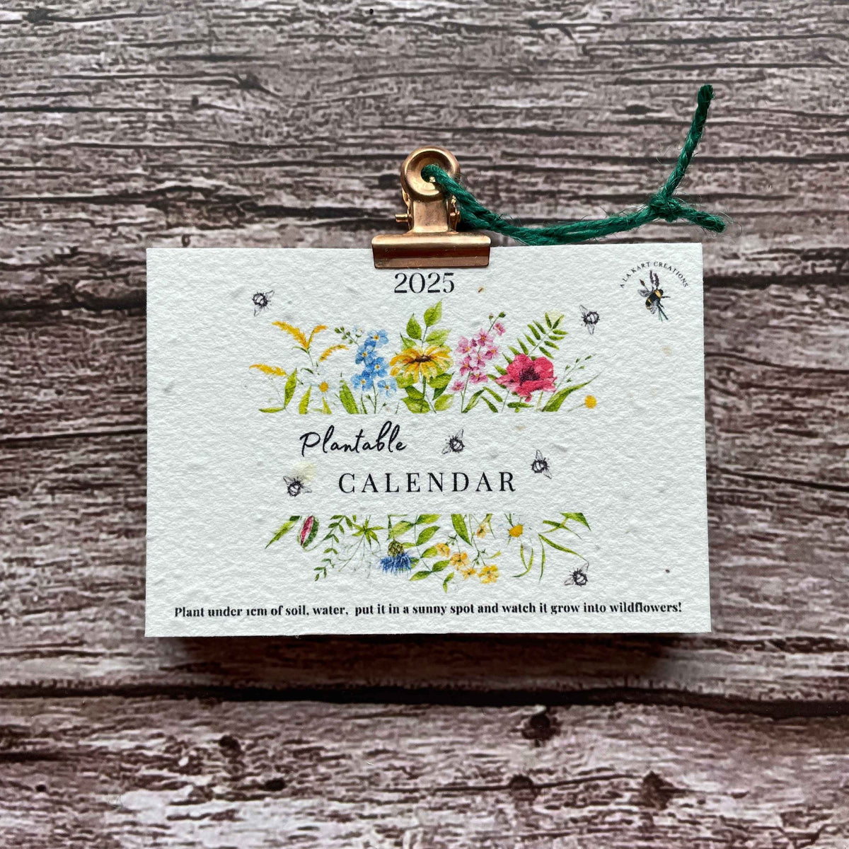 2025 wall calendar featuring a "Wildflower Meadow" design made from plantable seed paper, allowing users to grow vibrant wildflowers after use, promoting sustainability and eco-friendliness, alakartcreations