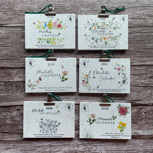 range of plantable calendars on wooden background with floral designs