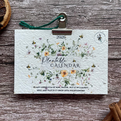 2026 seed paper calendar with floral design on a wooden surface