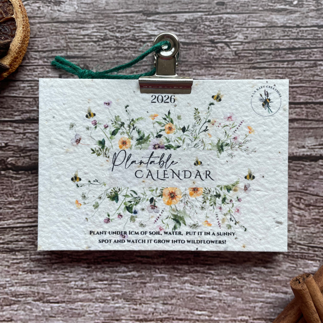 2026 seed paper calendar with floral design on a wooden surface