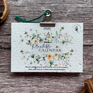 2026 seed paper calendar with floral design on a wooden surface