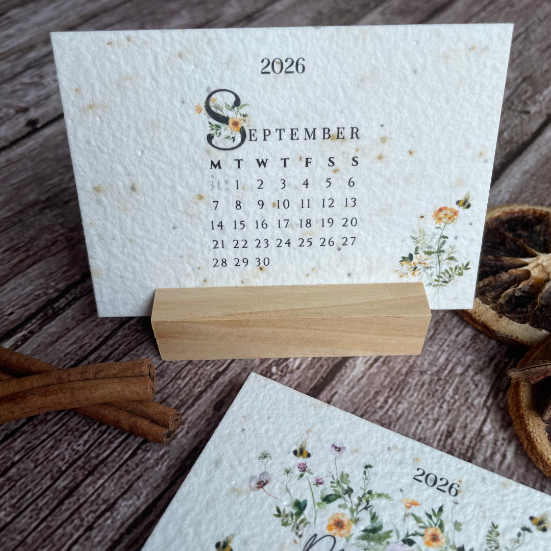 Seed paper 2026 calendar cards with floral designs on a wooden stand