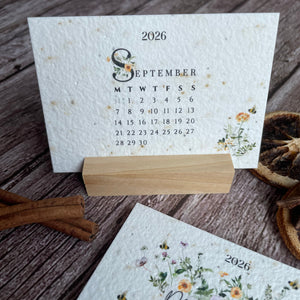 Seed paper 2026 calendar cards with floral designs on a wooden stand