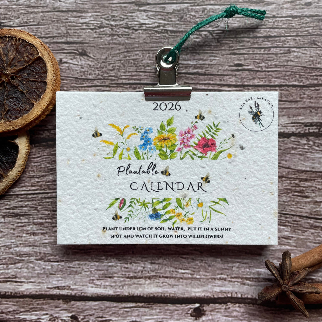Floral design 2026 plantable calendar on a wooden surface with decorative elements