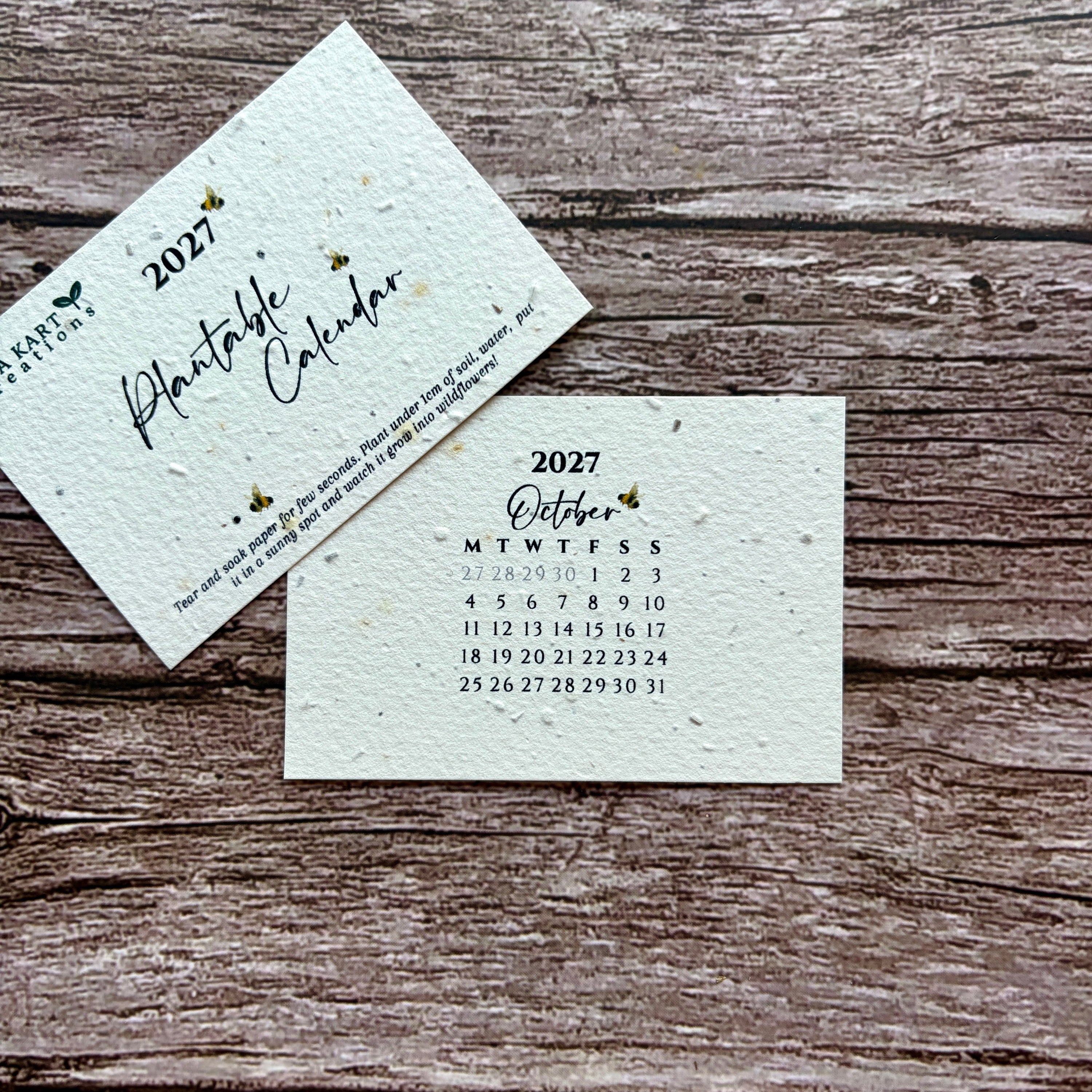 Two square paper calendar cards for 2027, one showing the cover with the title &