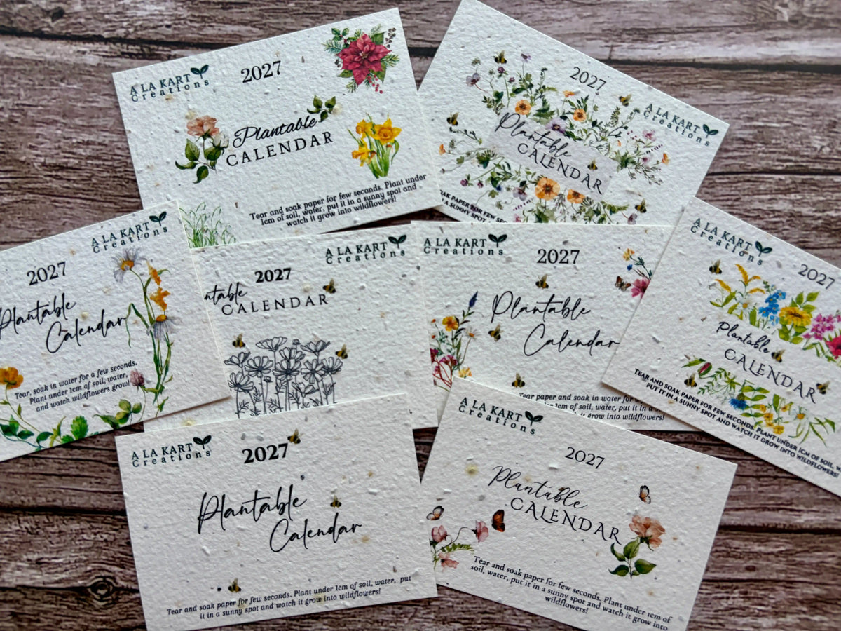 2027 seed paper calendar collection on a wooden background with floral designs