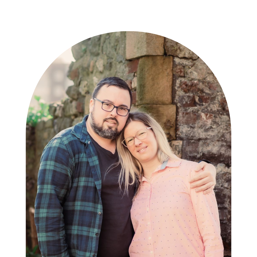 The founders of A La KArt Creations, Kitti and James, photographed in a stone archway. 