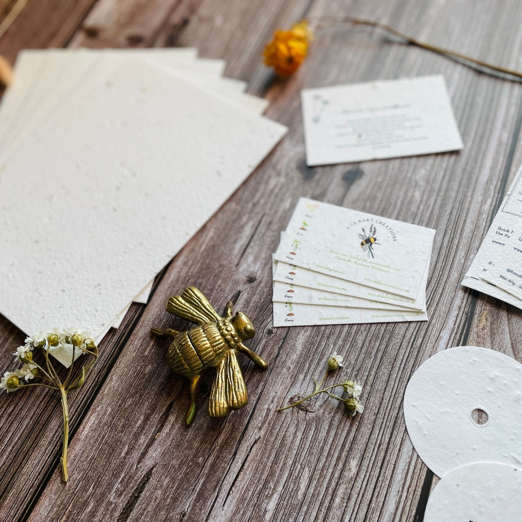 Plantable business stationery showcased on a wooden backdrop with wildflowers