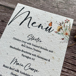 plantable autumn themed Menu card with floral design on a wooden surface