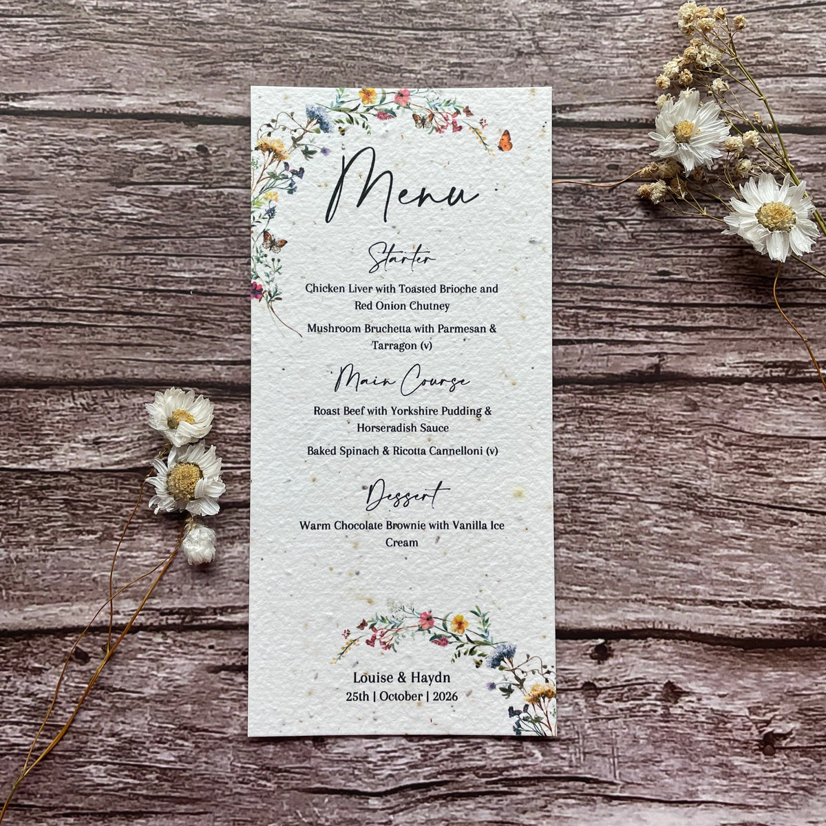 Seed Paper Floral menu card on a wooden surface with dried flowers