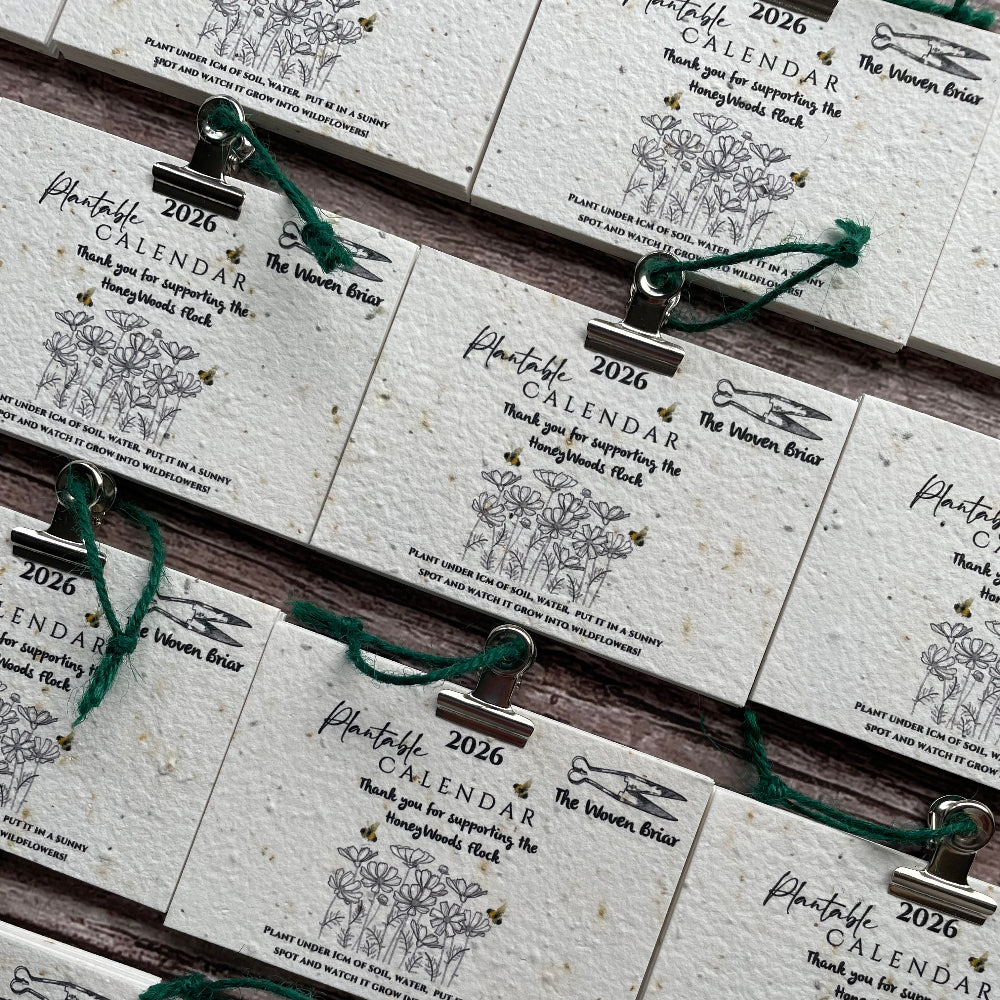 Stack of plantable calendar pages with decorative elements.