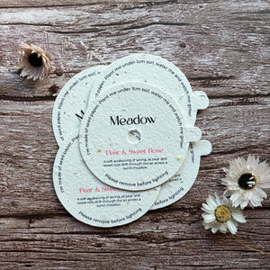 customised candle dust cover made from seed paper on a wooden surface