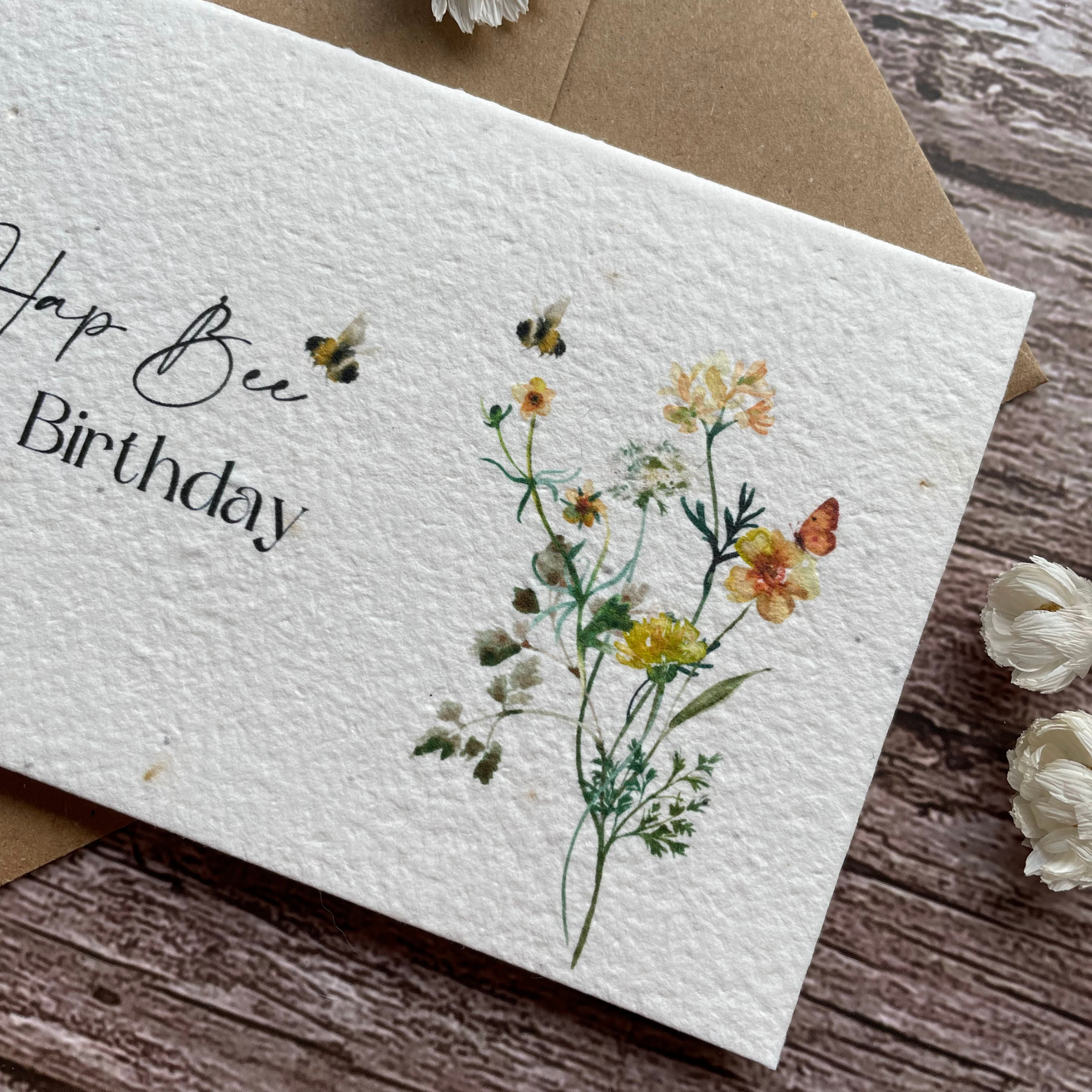 close-up of plantable birthday card with bees and wildflowers design, highlighting the intricate details of the artwork