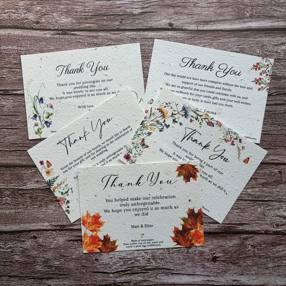 Plantable wedding Thank you cards with autumn leaf designs on a wooden surface
