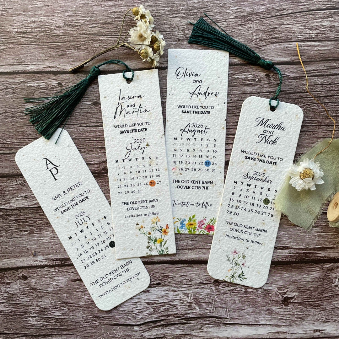 front view of personalised plantable wedding save the date bookmarks on a wooden background, feat elegant floral designs and tassels, alakartcreations