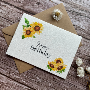 angled view of personalised plantable seed paper birthday card with sunflower design, made from uk seed paper, available at a la kart creations