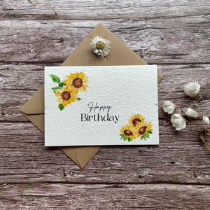 front view of personalised plantable birthday card featuring vibrant sunflowers, handmade with uk seed paper, available at a la kart creations