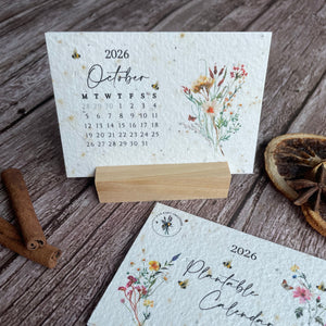 2026 seed paper calendar with floral design on a wooden surface.