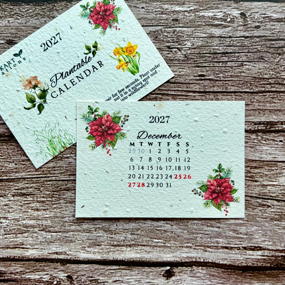Two small decorative plantable calendar cards for 2027 displayed on a rustic weathered wood surface. 
