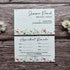 Two appointment reminder cards with floral designs on a wooden surface.
