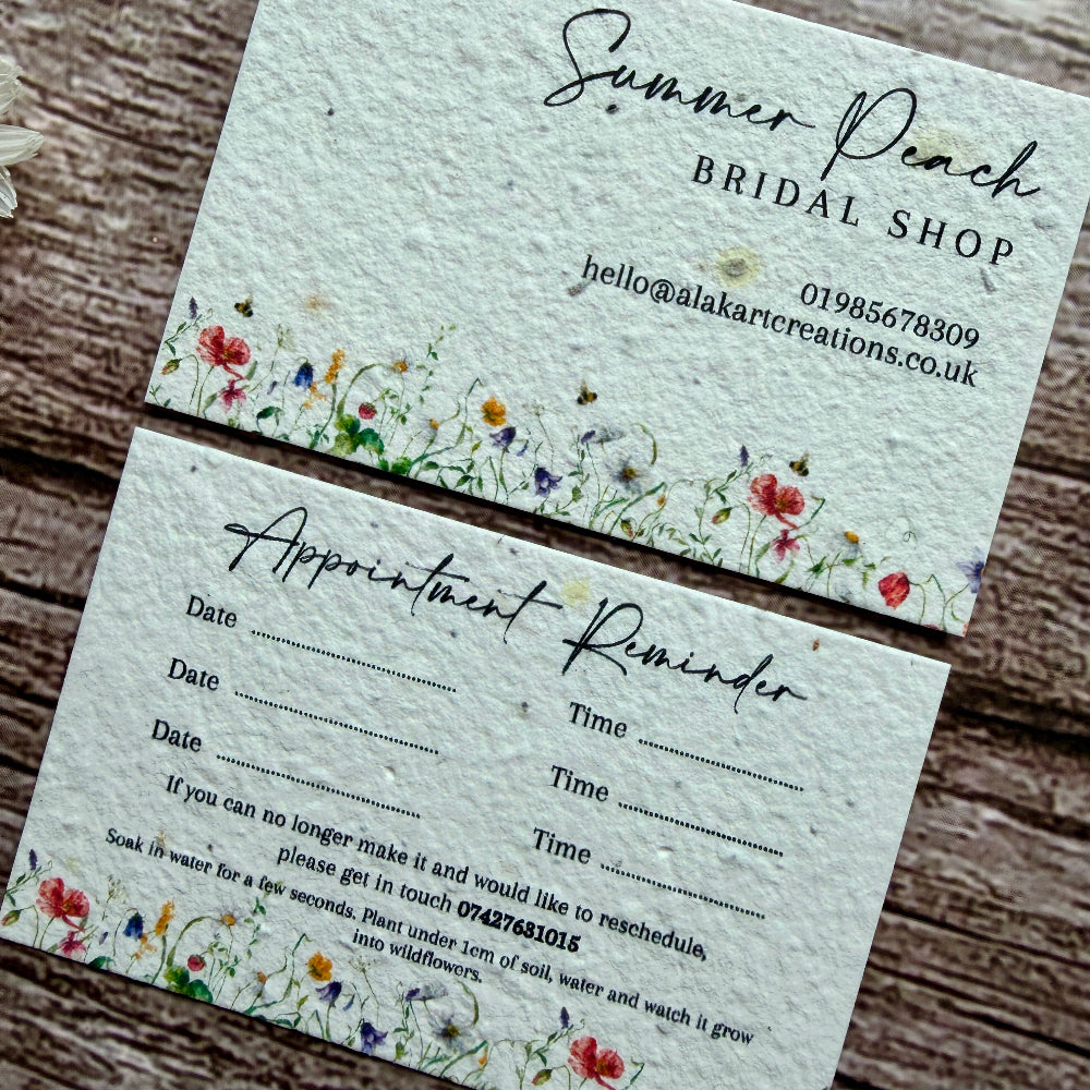 plantable appointment card for Summer Peach Bridal Shop with appointment reminder details on a wooden surface.