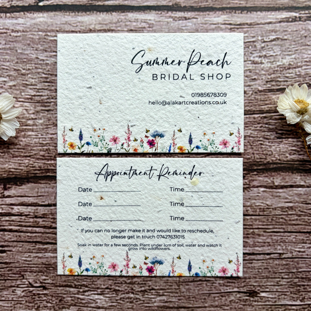Plantable appointment reminder card with floral design on a wooden surface