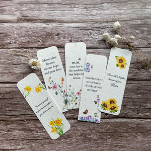 collection of mother's day plantable bookmarks on a wooden surface