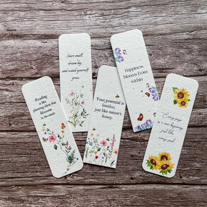 Set of plantable floral bookmarks on a wooden surface