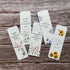 Set of plantable floral bookmarks on a wooden surface