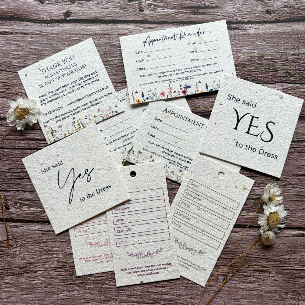 Set of plantable say yes to dress card, wedding dress tags and appointment reminder for bridal boutiques made of seed paper on wooden surface.